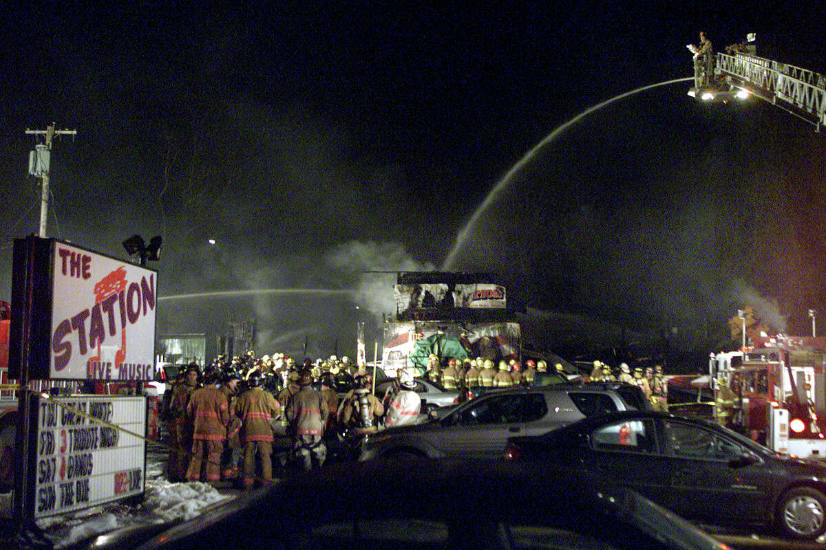 In this Feb. 20, 2003 file photo, firefighters spray water on to the charred nightclub, The Station, where 100 people were killed and more than 200 people were injured in West Warwick, R.I.