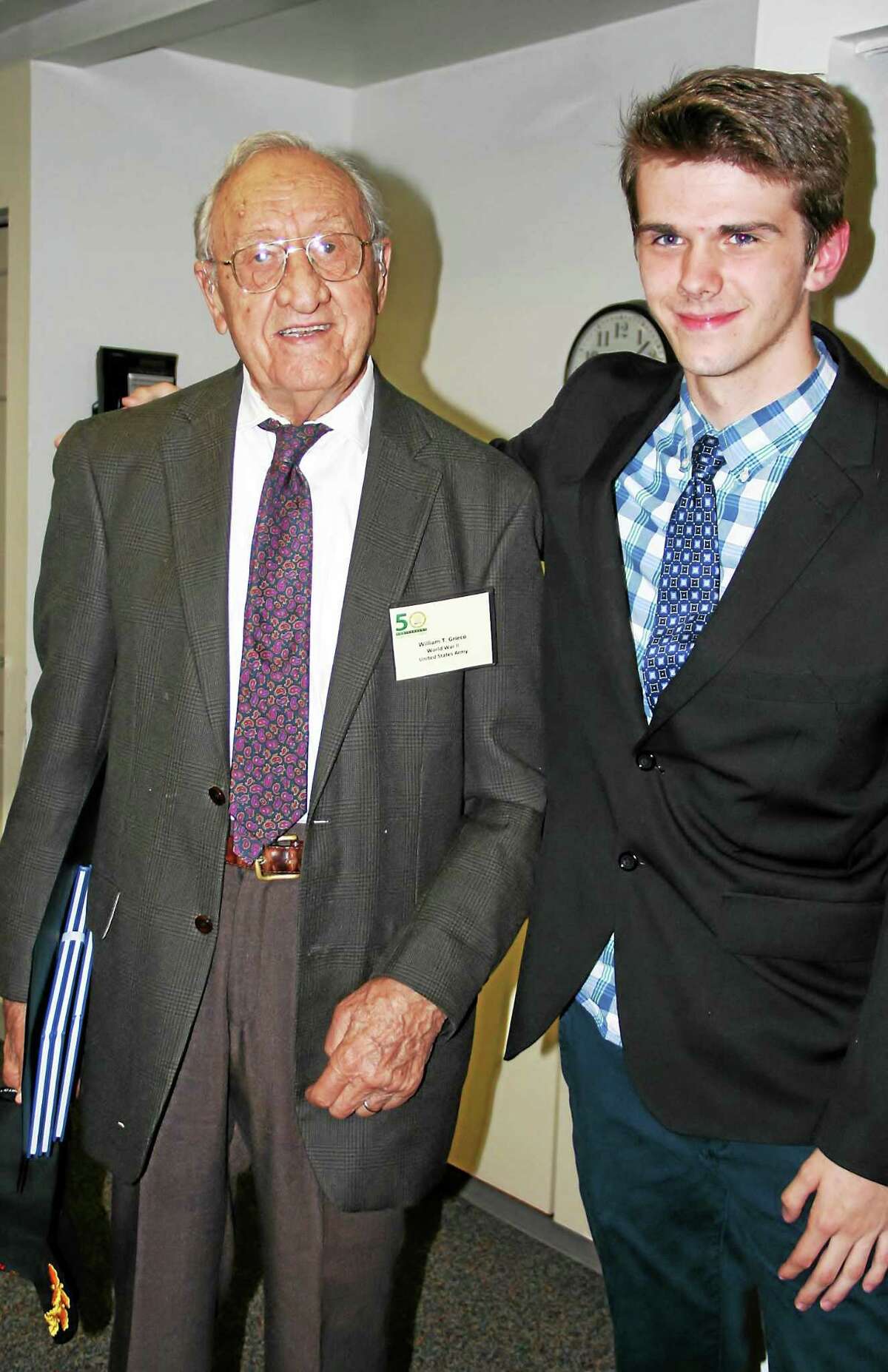 William T. Grieco, left, a European World War II veteran from Torrington, with his interviewer, Torrington High School student Richard James Baker, at the veterans project ceremony Thursday in Founders Hall auditorium on the campus of Northwestern Connecticut Community College.