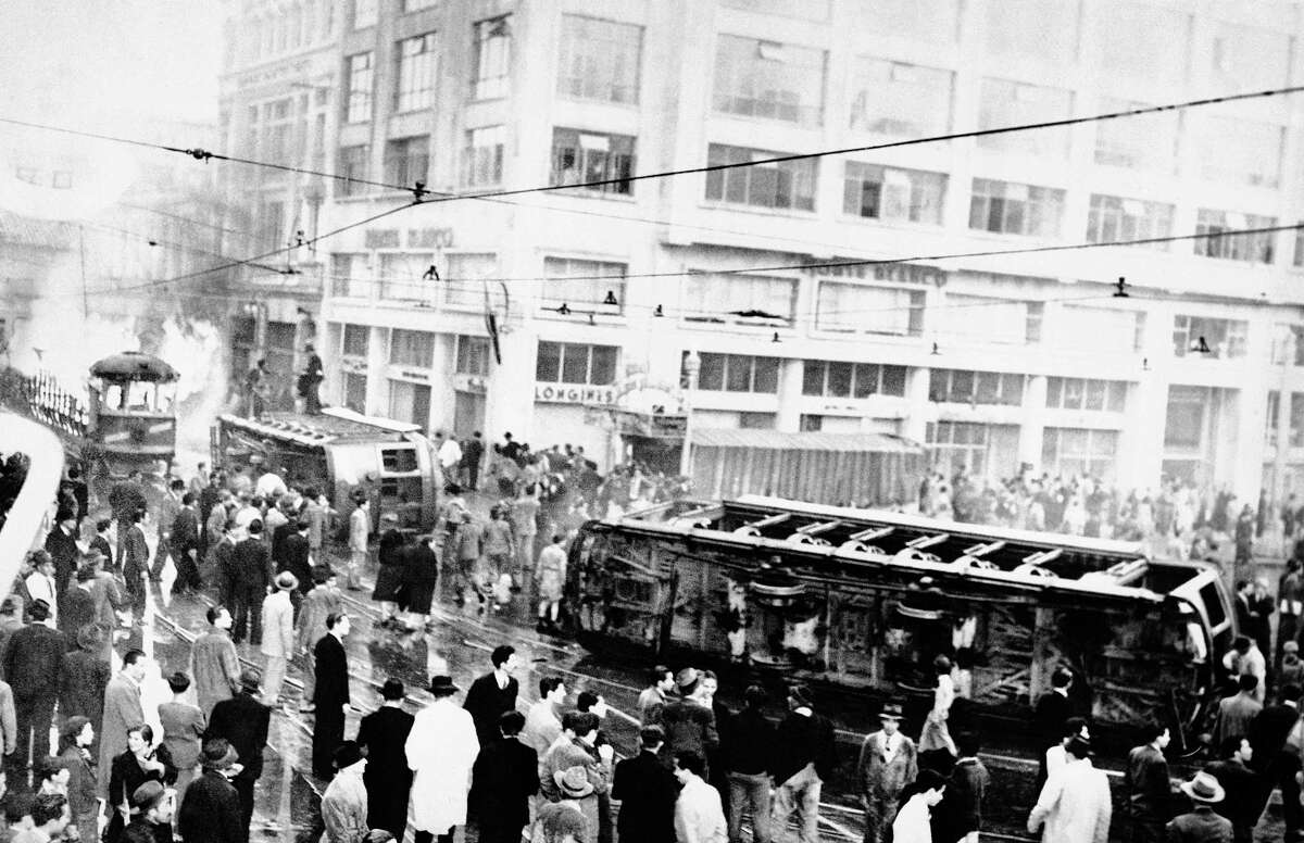 FILE - In this April 9, 1948, file photo, a streetcar lays overturned outside the Granada Hotel in Bogota, Colombia during an uprising after the death of Jorge Eliecer Gaitan. The mob also sacked and set fire to the government house, right. The 1948 assassination of populist firebrand led to a political bloodletting known as “The Violence.” Tens of thousands died, and peasant groups joined with communists to arm themselves. A 1964 military attack on their main encampment led to the creation of the Revolutionary Armed Forces of Colombia, or FARC.
