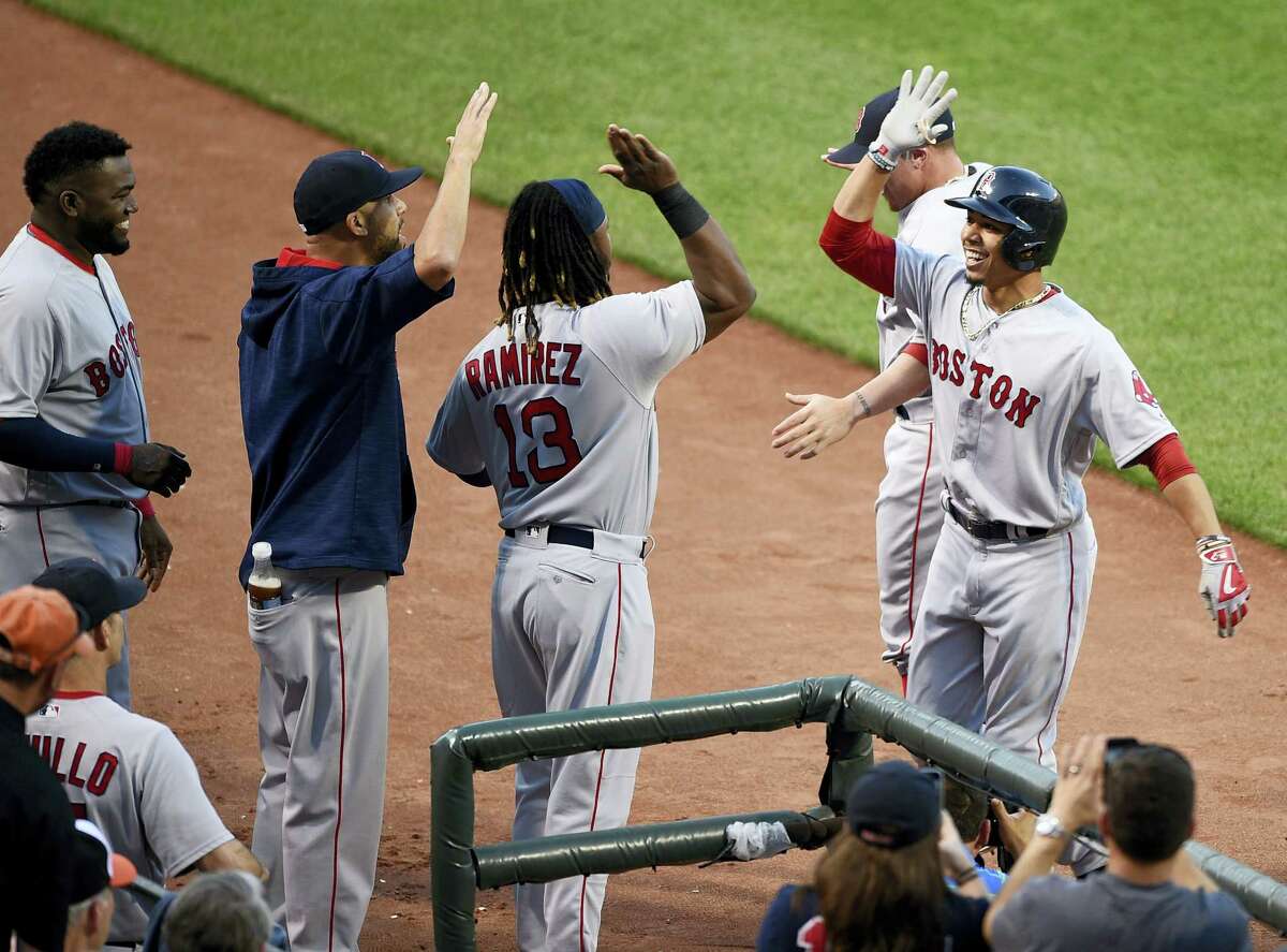 Boston’s Mookie Betts, right, celebrates his home run with Hanley Ramirez (13) during the second inning against the Baltimore Orioles, Wednesday in Baltimore.