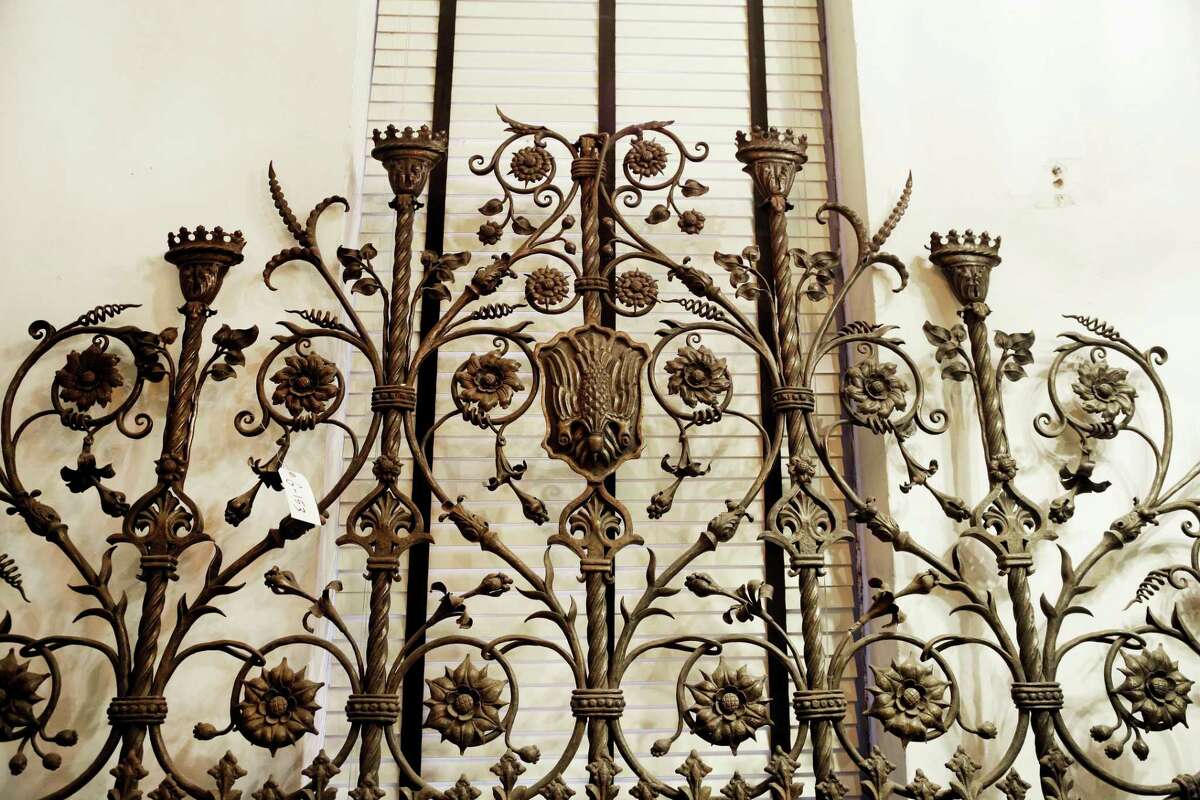 In this Tuesday, March 10, 2015 photo, a section of the St. Patrickís Cathedral Baptistery gates is part of a collection of historic artifacts at Urban Archeology in New York. The former salvage company that years ago switched to the manufacture of tile, lighting and bathroom accessories based on iconic designs, is auctioning off approximately 6,000 artifacts saved from destruction, nearly its entire salvage inventory. (AP Photo/Mark Lennihan)