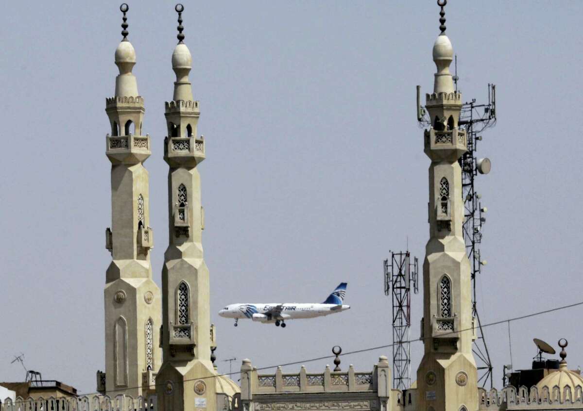 An EgyptAir plane flies past minarets of a mosque as it approaches Cairo International Airport, in Cairo, Egypt. A French company says Wednesday, June 2, 2016 its equipment aboard a French naval ship has detected signals from one of the black box flight recorders on the EgyptAir flight that crashed into the Mediterranean Sea last month.