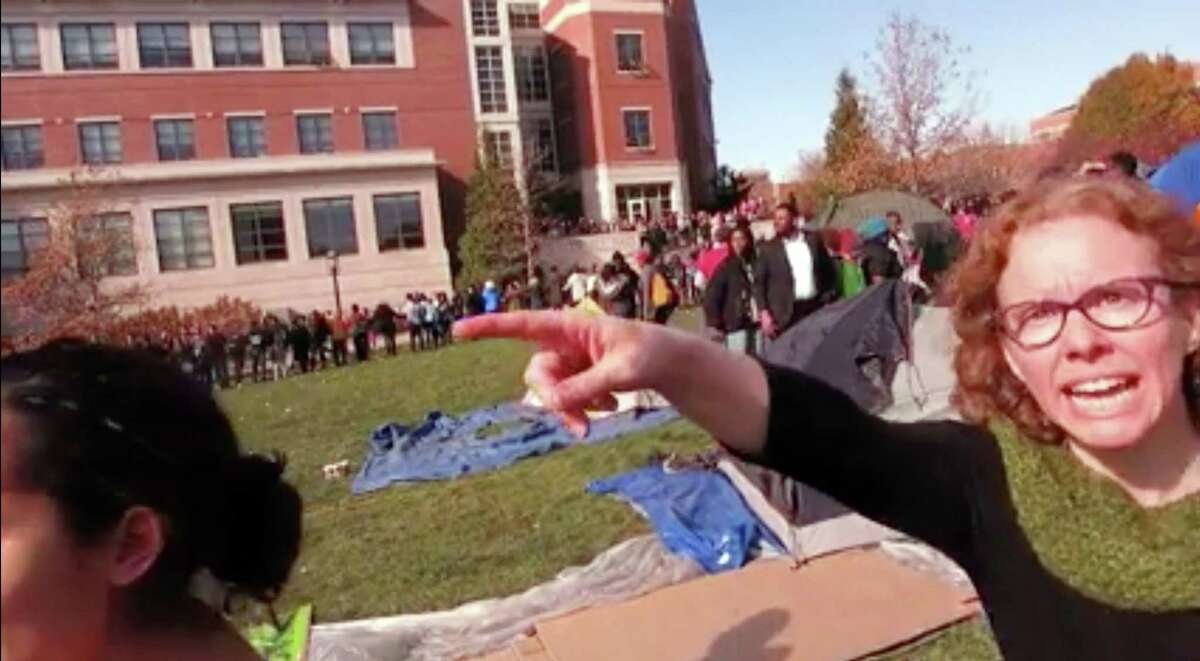 In this Nov. 9, 2015, frame from video provided by Mark Schierbecker, Melissa Click, right, an assistant professor in Missouri’s communications department, confronts Schierbecker and later calls for “muscle” to help remove him from the protest area in Columbia, Mo. Protesters are credited with helping oust the University of Missouri System’s president, and the head of its flagship campus welcomed reporters to cover their demonstrations Tuesday, a day after a videotaped clash between some protesters and a student photographer drew media condemnation as an affront to the free press.