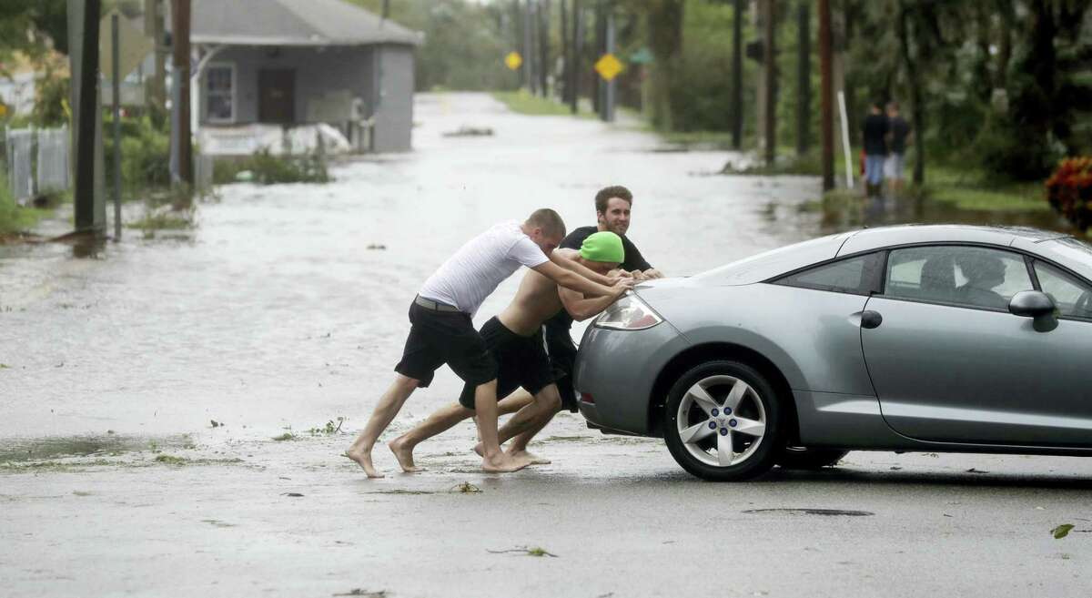 Noah Simons steers as his car is pushed out of flood waters caused by Hurricane Matthew, Friday, Oct. 7, 2016, in Daytona Beach, Fla. Hurricane Matthew spared Florida’s most heavily populated stretch from a catastrophic blow Friday but threatened some of the South’s most historic and picturesque cities with ruinous flooding and wind damage as it pushed its way up the coastline.