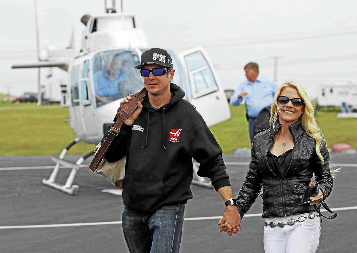In this May 17, 2014 file photo, Kurt Busch, left, walks with his girlfriend, Patricia Driscoll, after arriving for the NASCAR Sprint All-Star race at Charlotte Motor Speedway in Concord, N.C.