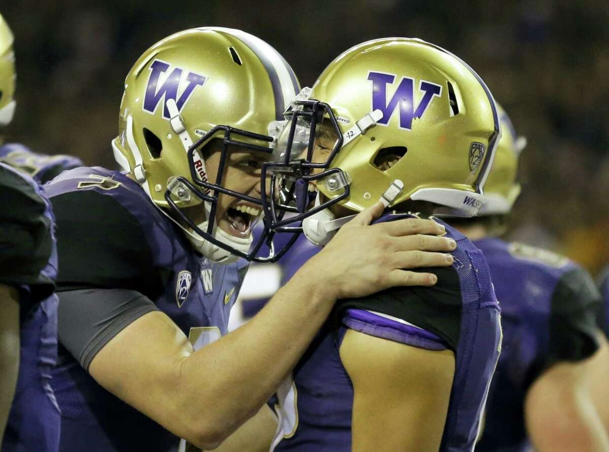 In this Sept. 30, 2016 photo, Washington quarterback Jake Browning, left, celebrates with wide receiver Aaron Fuller after Fuller caught a pass from Browning for a touchdown in the second half of an NCAA college football game, in Seattle. The Huskies are coming off smashing Stanford and have a top-five ranking for the first time since the end of the 2001 season.