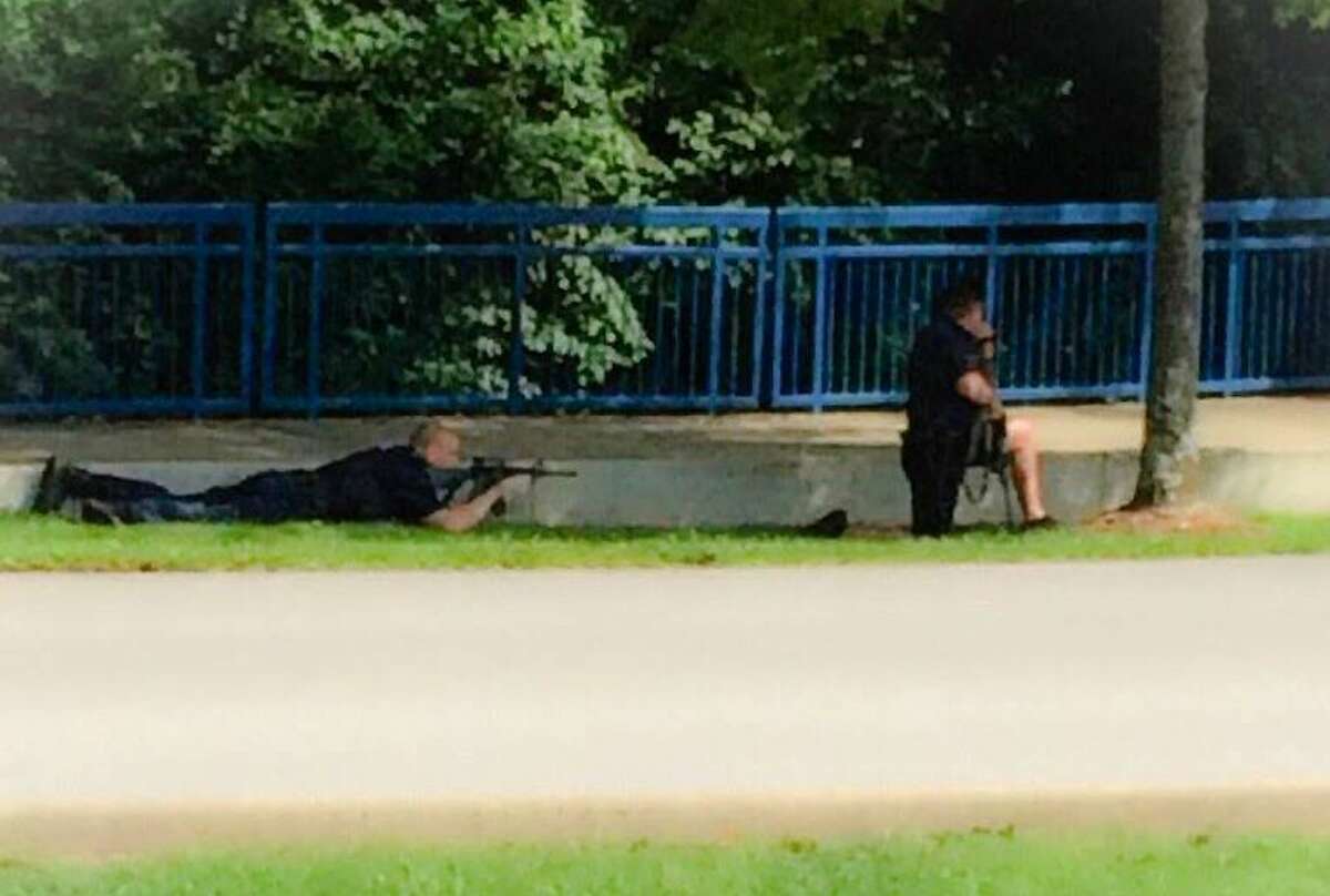 In this image made from video and released by WRCB-TV, authorities work an active shooting scene on amincola highway near the Naval Reserve Center, in Chattanooga, Tenn. on Thursday, July 16, 2015. Chattanooga Mayor Andy Berke says police are pursuing an active shooter after reports of a shooting at the military reserve center.