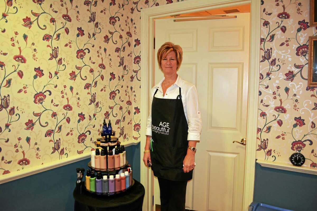 New owner Jennifer Tyrrell stands inside the Fifty Shades of Grey Hair Salon.