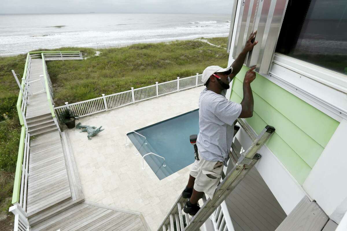 Dimitri Pinckney installs hurricane shutters in advance of Hurricane Matthew on the Isle of Palms, S.C., Wednesday, Oct. 5, 2016. Hurricane Matthew is expected to affect the South Carolina coast by the weekend. Gov. Nikki Haley announced Tuesday that, unless the track of the storm changes, the state will issue an evacuation order Wednesday to help get 1 million people inland from the coast.