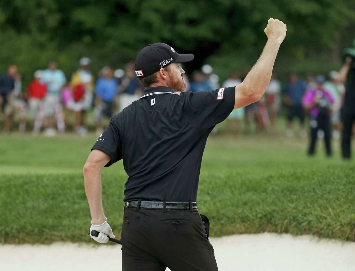 Jimmy Walker reacts after holing out from a sand trap on the 10th hole during the final round of the PGA Championship at Baltusrol Golf Club in Springfield, N.J., Sunday.