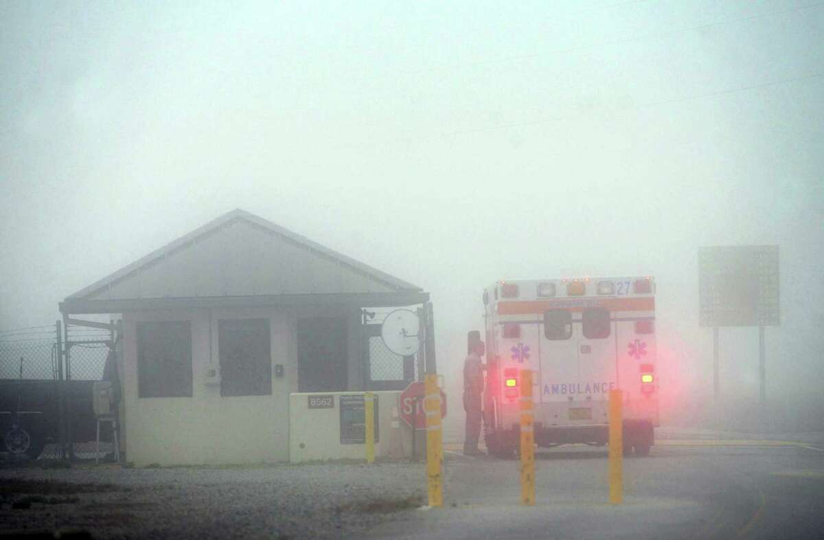 An Okaloosa County ambulance sits at the Eglin Air Force entrance in Fort Walton Beach, Fla., Wednesday, March 11, 2015. Seven Marines and four soldiers aboard an Army helicopter that crashed over waters off Florida during a routine night training mission were presumed dead Wednesday, and crews found human remains despite heavy fog hampering search efforts, military officials said.