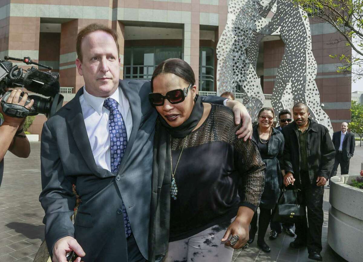 Attorney Richard Busch, left, and Nona Gaye, daughter of the late Marvin Gaye, leave the Los Angeles U.S. District Court after a jury awarded the singer's children nearly $7.4 million after determining singers Robin Thicke and Pharrell Williams copied their father's music to create "Blurred Lines," Tuesday, March 10, 2015. Gaye died in April 1984, leaving his children the copyrights to his music. In the background, right, is Marvin Gaye's ex-wife, Jan Gaye, and son, Frankie Gaye. (AP Photo/Nick Ut)
