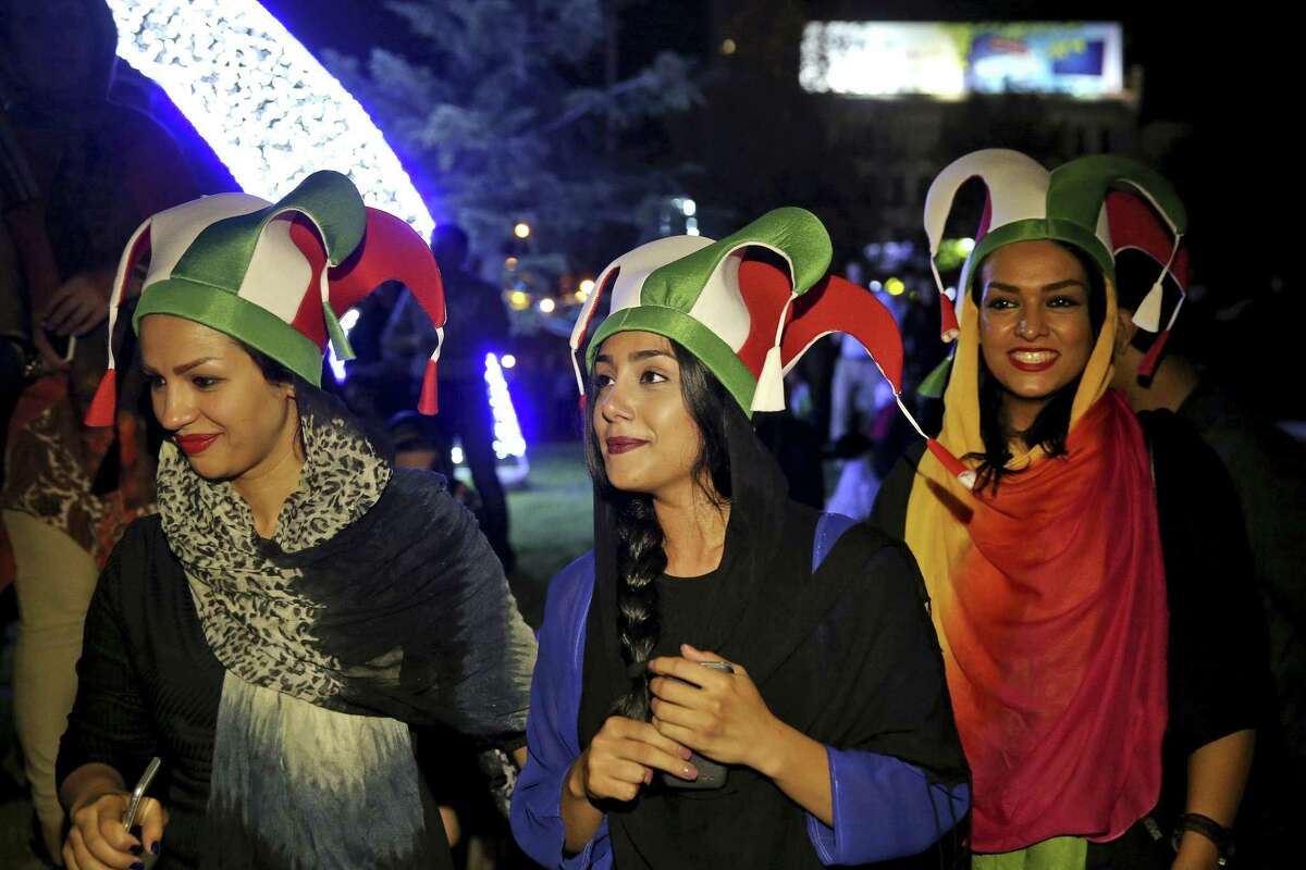 Iranian women take part in street celebrations following a landmark nuclear deal, in Tehran, Iran, Tuesday, July 14, 2015. Overcoming decades of hostility, Iran, the United States, and five other world powers struck a historic accord Tuesday to check Tehran's nuclear efforts short of building a bomb. The agreement could give Iran access to billions in frozen assets and oil revenue, stave off more U.S. military action in the Middle East and reshape the tumultuous region. (AP Photo/Ebrahim Noroozi)