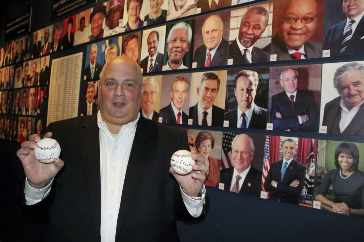 In this photo taken Sept. 30, 2016, Randy Kaplan holds autographed baseballs in Garden City, N.Y., signed by presidential candidates Donald Trump and Hillary Clinton. Kaplan has collected more than 200 signed baseballs from world leaders, including current and former U.S. presidents, prime ministers and others. The baseballs are on display at the Cradle of Aviation Museum on Long Island through next month’s election.