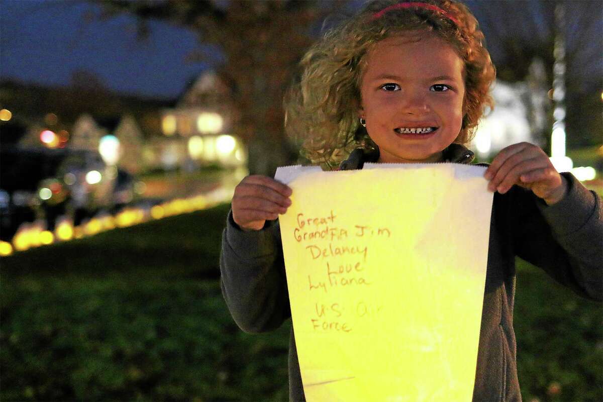 Lyliana Martinez, 5, hold the luminary bag she made for her great grandpa Jim Delancy, who is commander of the Andrew B. Mygatt VFW Post 1672.
