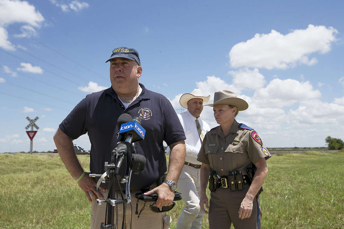 National Transportation Safety Board Senior Advisor Erik Grosof, left, Caldwell County Sheriff Daniel Law and Texas DPS Trooper Robbie Barrera, right, leave the scene of a hot air balloon disaster Saturday, July 30, 2016, near Lockhart, Texas, causing what authorities described as a “significant loss of life.”