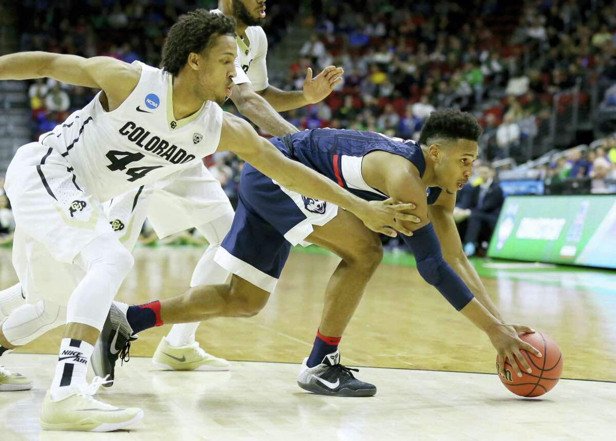 UConn guard Jalen Adams, right, fights for a loose ball with Colorado guard Josh Fortune during the first half Thursday. On Saturday, Adams will play against former Pop Warner teammate Wayne Seldon of Kansas.