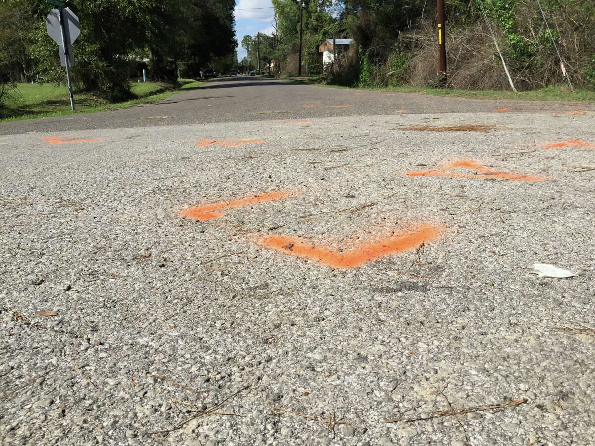 This Nov. 4, 2015 image shows orange paint marking the spot where a 6-year-old boy was shot and killed by Ward 2 city marshals in Marksville, La. The marshals had been chasing a vehicle driven by the boy’s father, Chris Few. He was shot in the head, but survived.
