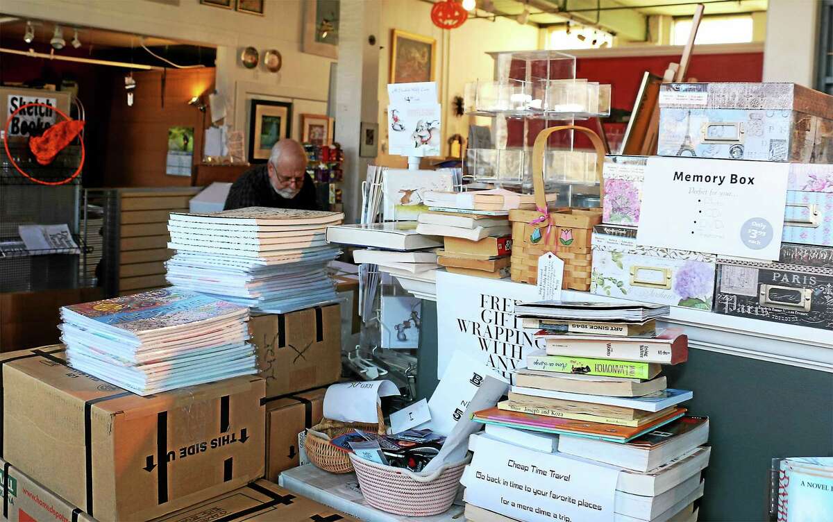 Many items have already been packed at Dickens Books and Art. In background is co-owner Bob Schwalb.