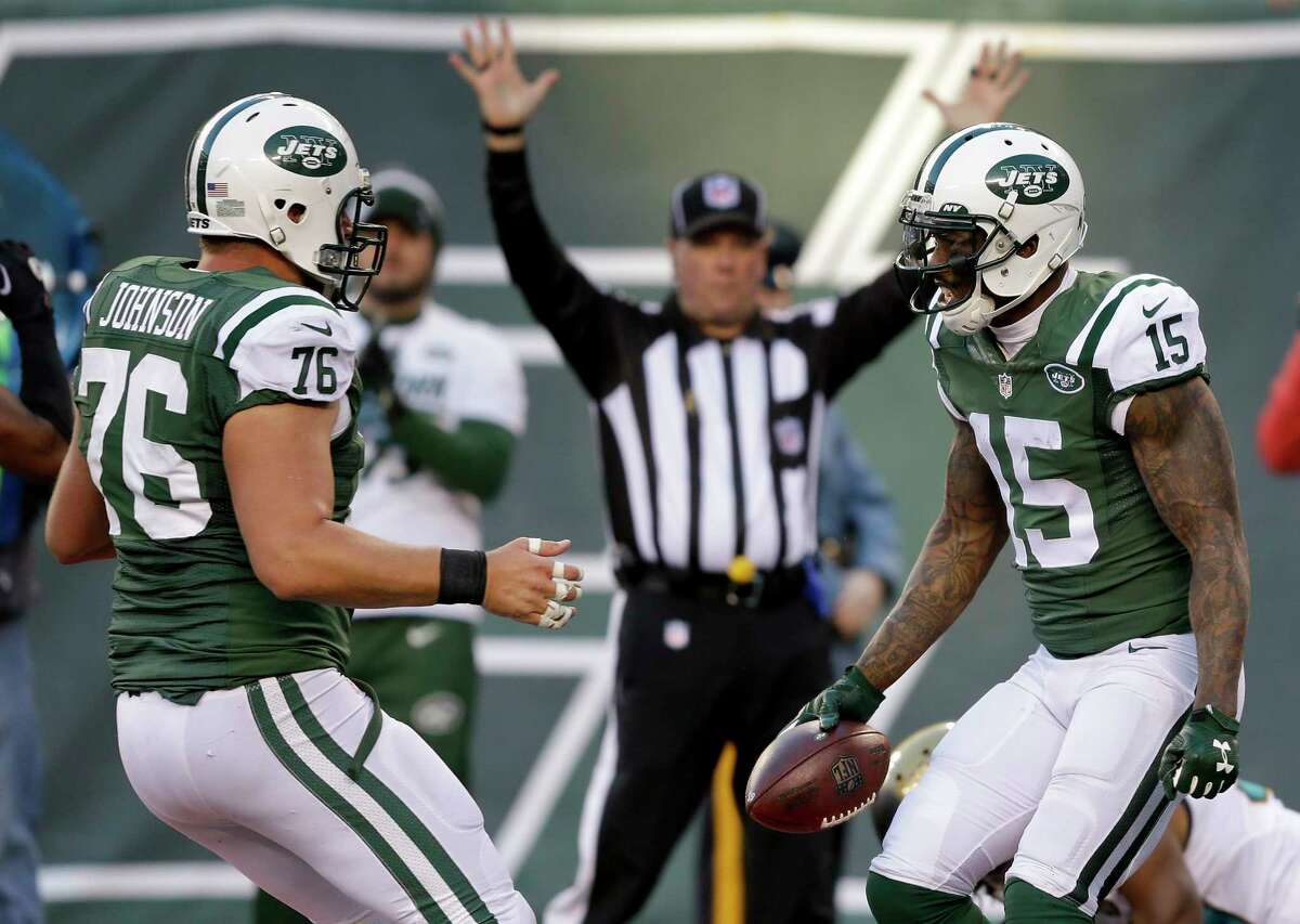 Jets wide receiver Brandon Marshall (15) celebrates with center Wesley Johnson after scoring a touchdown against Jaguars in the fourth quarter on Sunday.