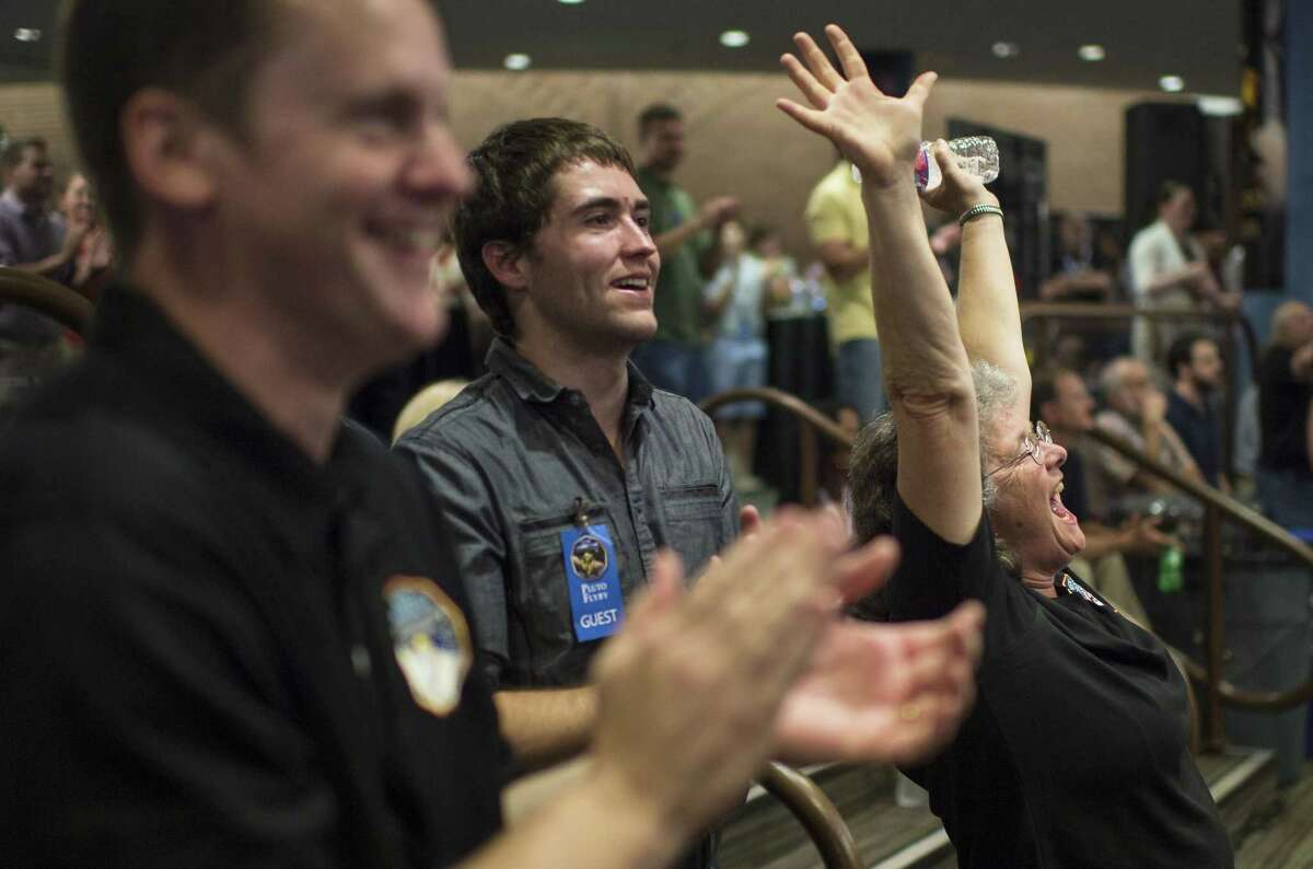Fran Bagenal, a member of the New Horizons science team reacts Tuesday after the team received confirmation from the spacecraft that it has completed the flyby of Pluto.