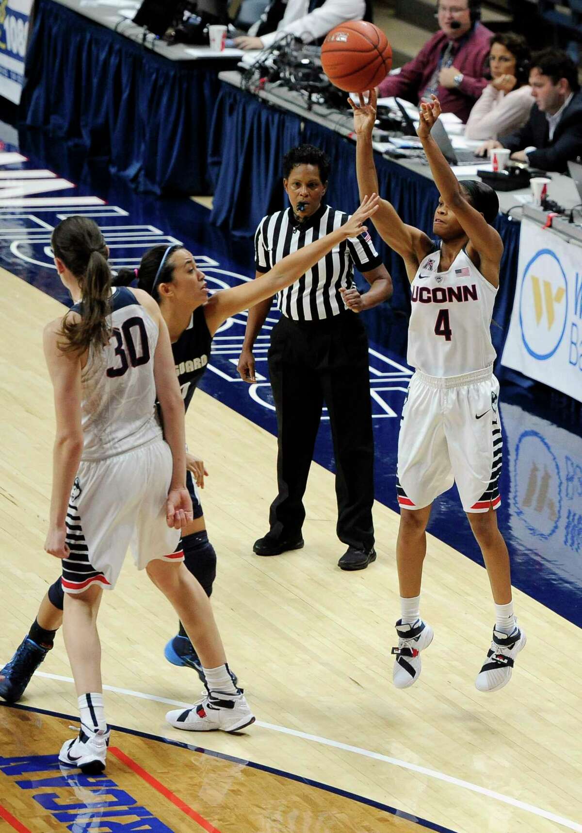 UConn’s Moriah Jefferson, right, shoots a 3-point basket against Vanguard’s Maya Kennedy as Breanna Stewart, left, defends during the second half Sunday.