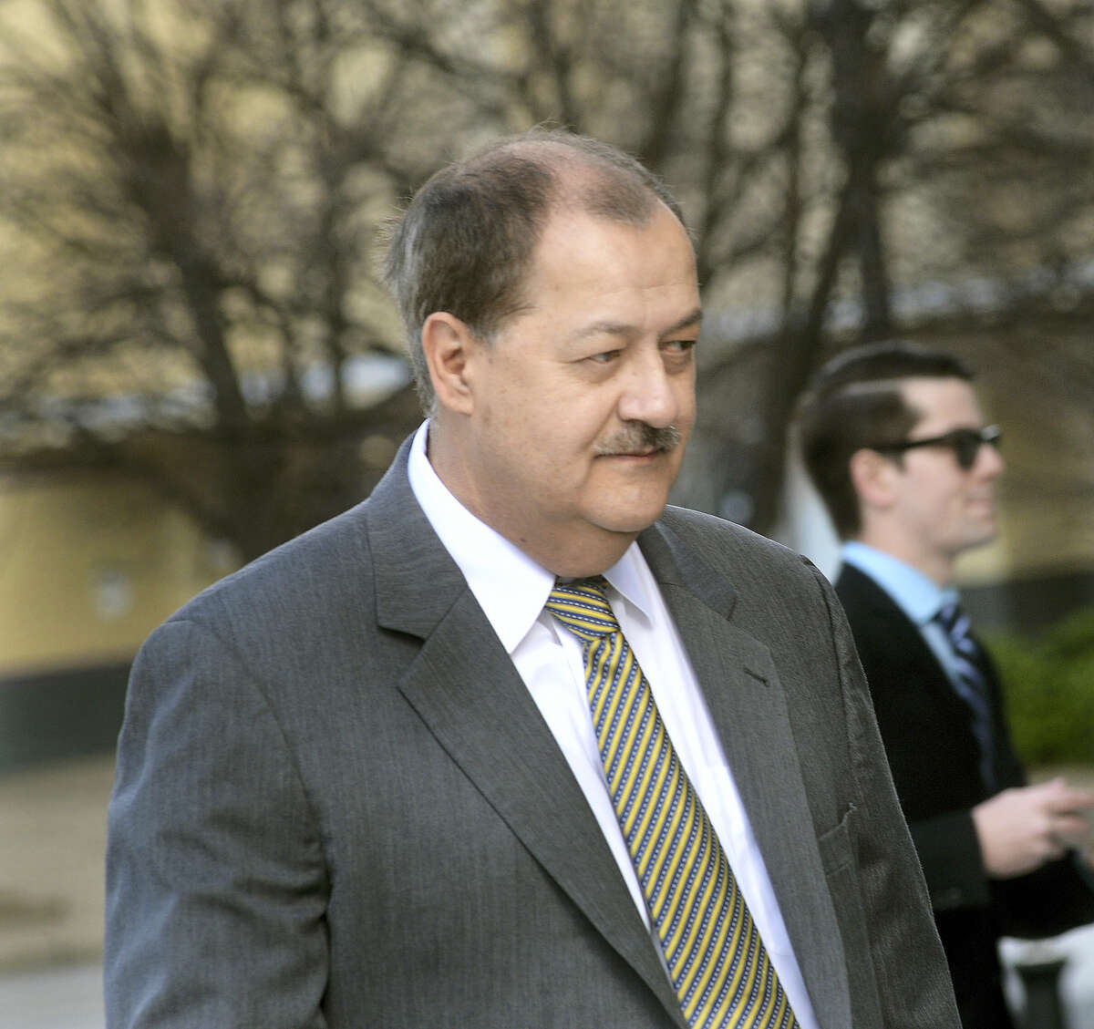 In an April 6, 2016 photo, former Massey CEO Don Blankenship is escorted by Homeland Security officers from the Robert C. Byrd U.S. Courthouse in Charleston, W.Va. Blankenship, who was sentenced to a year in jail and a $250,000 fine for his role in the Upper Big Branch Mine explosion, has declared himself an ‘American political prisoner’ on his blog, blaming others for the 2010 mine explosion that killed 29 men and led to the former West Virginia coal operator’s imprisonment.