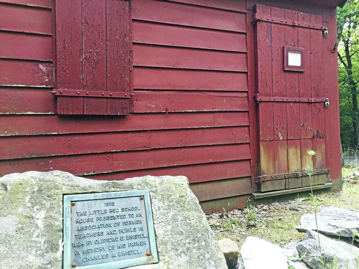 Ben Lambert - The Register CitizenA commemorative plaque in front of the vintage school house building explains its origins.