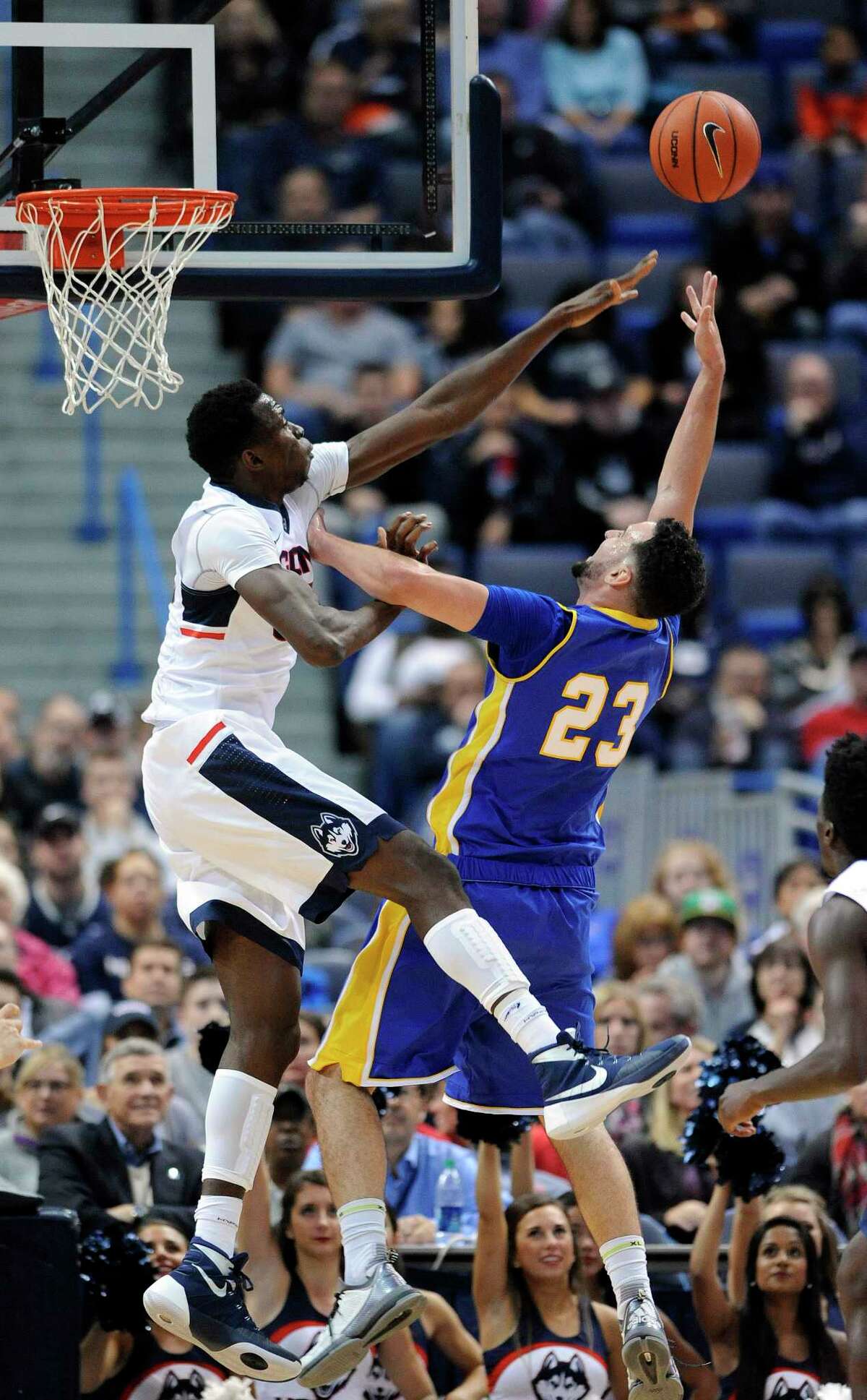 Connecticut's Amida Brimah (35) blocks the shot of New Haven's Joshua Guddemi (23) during the first half of an NCAA college basketball exhibition game in Hartford, Conn., on Saturday, Nov. 7, 2015. (AP Photo/Fred Beckham)