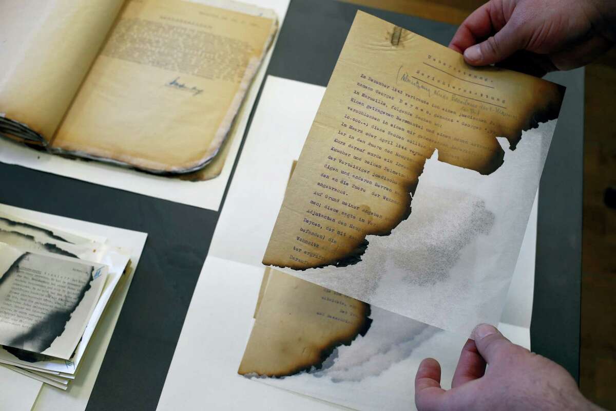 The files of the Gestapo (the Nazi secret police), partially burnt in a blaze in Marseille, and stored for years in the archives rooms of the medieval castle of Vincennes, are displayed in Vincennes, east of Paris, Wednesday, March 16, 2016. A team of French historians unveiled Wednesday some secret services’ archives from WWII, letters, reports, cables and photos from the rival intelligence agencies of the French Resistance, the collaborationist Vichy regime and the Nazi German authorities.