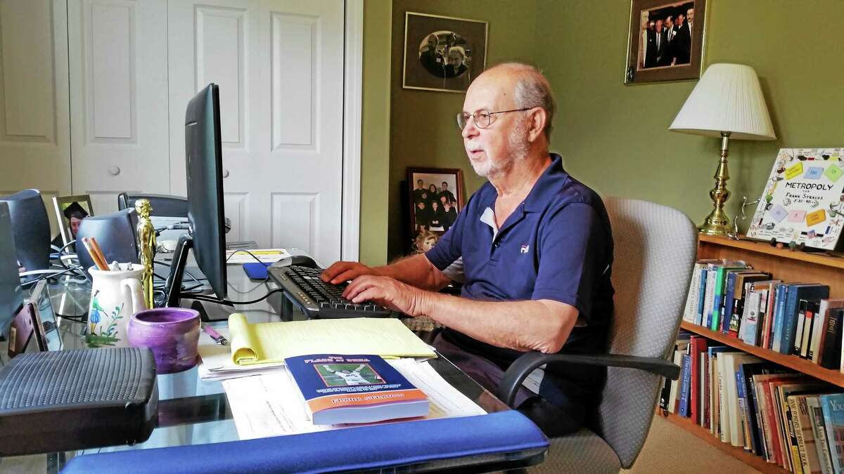 Goshen author Frank Strauss, 80, is pictured at his home office.