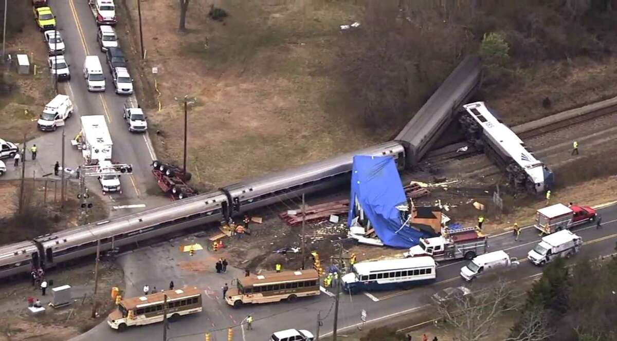 In this frame grab from video provided by WTVD-11, authorities respond to a collision between an Amtrak passenger train and a truck, Monday, March 9, 2015, in Halifax County, N.C. According to Halifax County Sheriff Wes Tripp, none of the injuries appeared to be life-threatening.