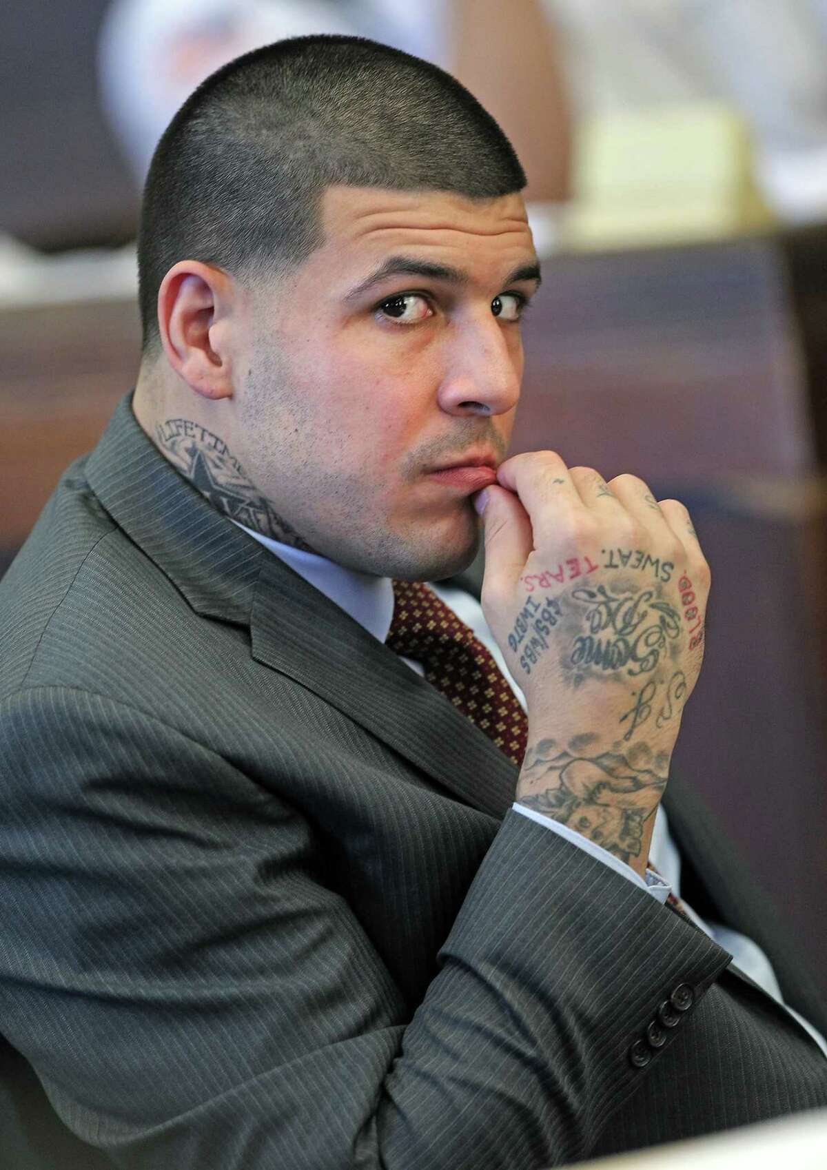 Former New England Patriots NFL football player Aaron Hernandez sits in the court room during his hearing at Suffolk Superior Court in Boston, Tuesday, Oct. 6, 2015. Lawyers for Hernandez have asked a judge to throw out a search warrant that led police to seize a vehicle that prosecutors say Hernandez was driving when he fatally shot two Boston men in 2012.