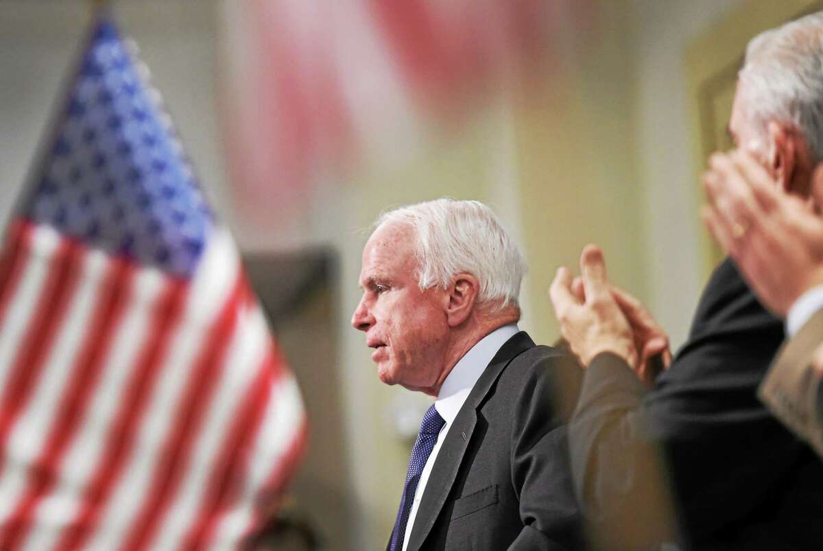 (Peter Hvizdak - New Haven Register) U.S. Senator John McCain (R-Ariz) gets a standing ovation during the Middlesex County Chamber of Commerce luncheon Monday, March 9, 2015 at the Crowne Plaza in Cromwell before he discusses his newly released book, "Thirteen Soldiers."