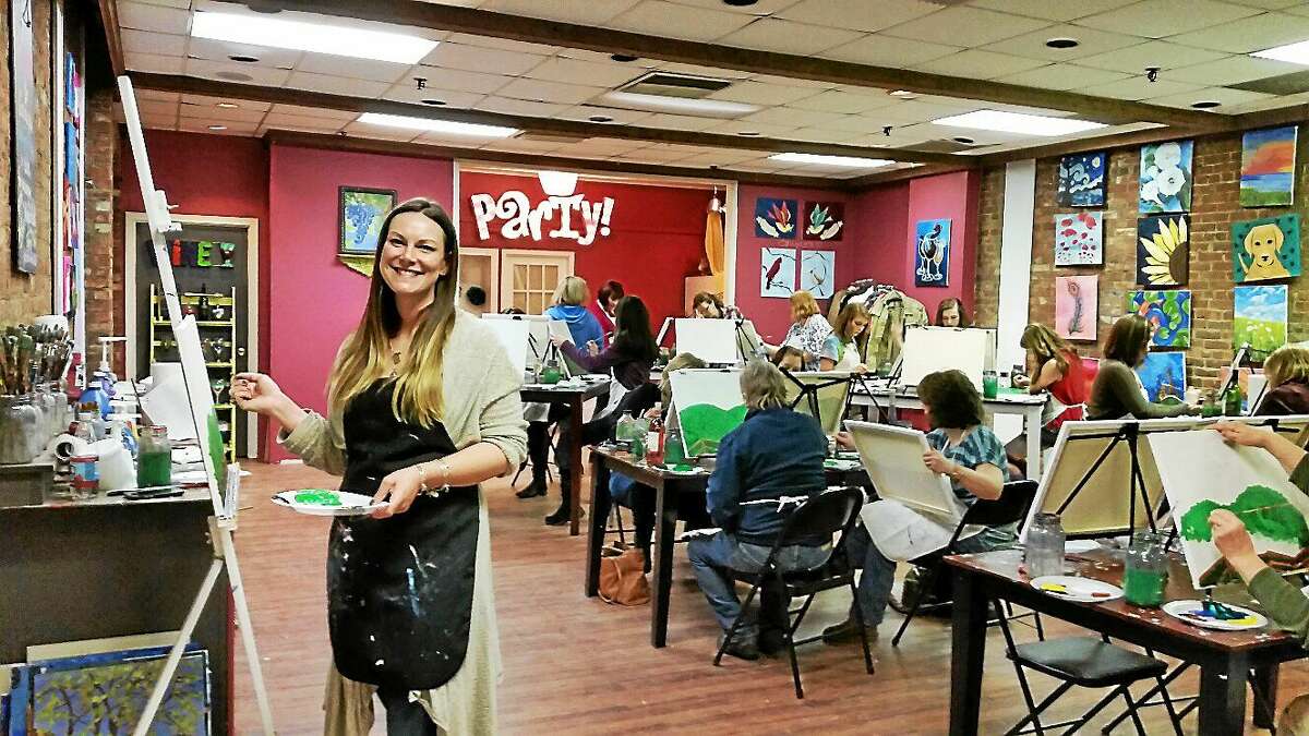 Torrington artist Carrie Taylor leads a “Cocktails & Canvases” fundraising party at The Arts Desire at 97 Main St. in Torrington on Sunday evening.
