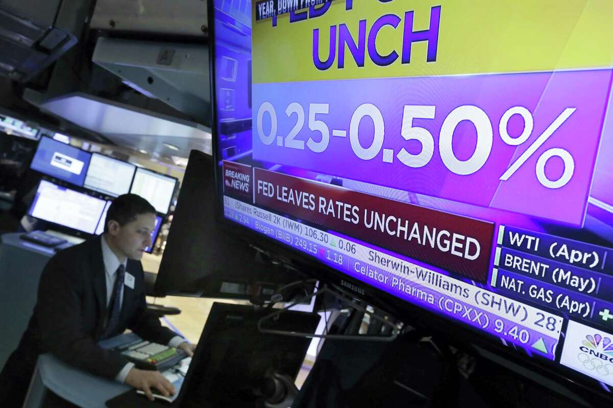 Specialist Jeffrey Berger works at his post on the floor of the New York Stock Exchange Wednesday.