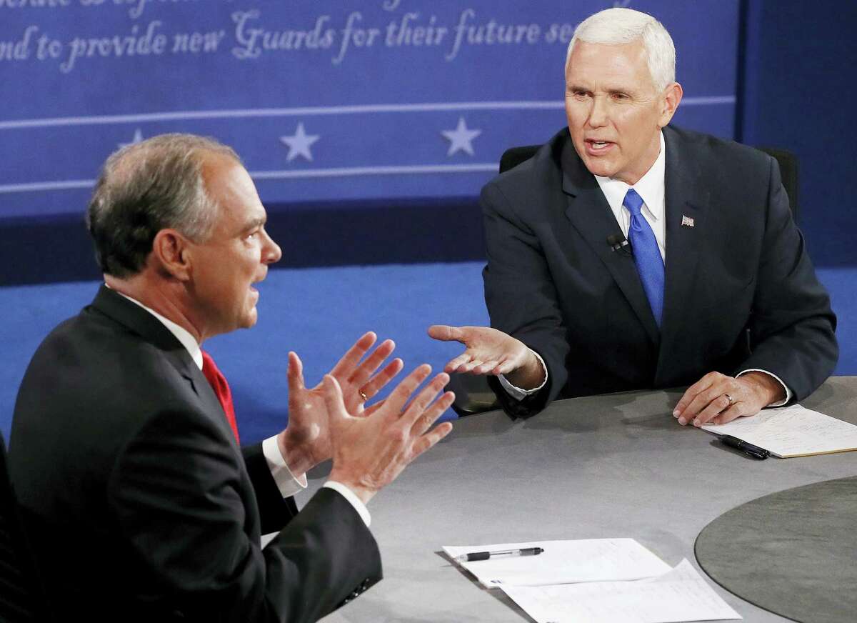 Republican vice-presidential nominee Gov. Mike Pence, right, and Democratic vice-presidential nominee Sen. Tim Kaine speak during the vice-presidential debate at Longwood University in Farmville, Va., Tuesday.