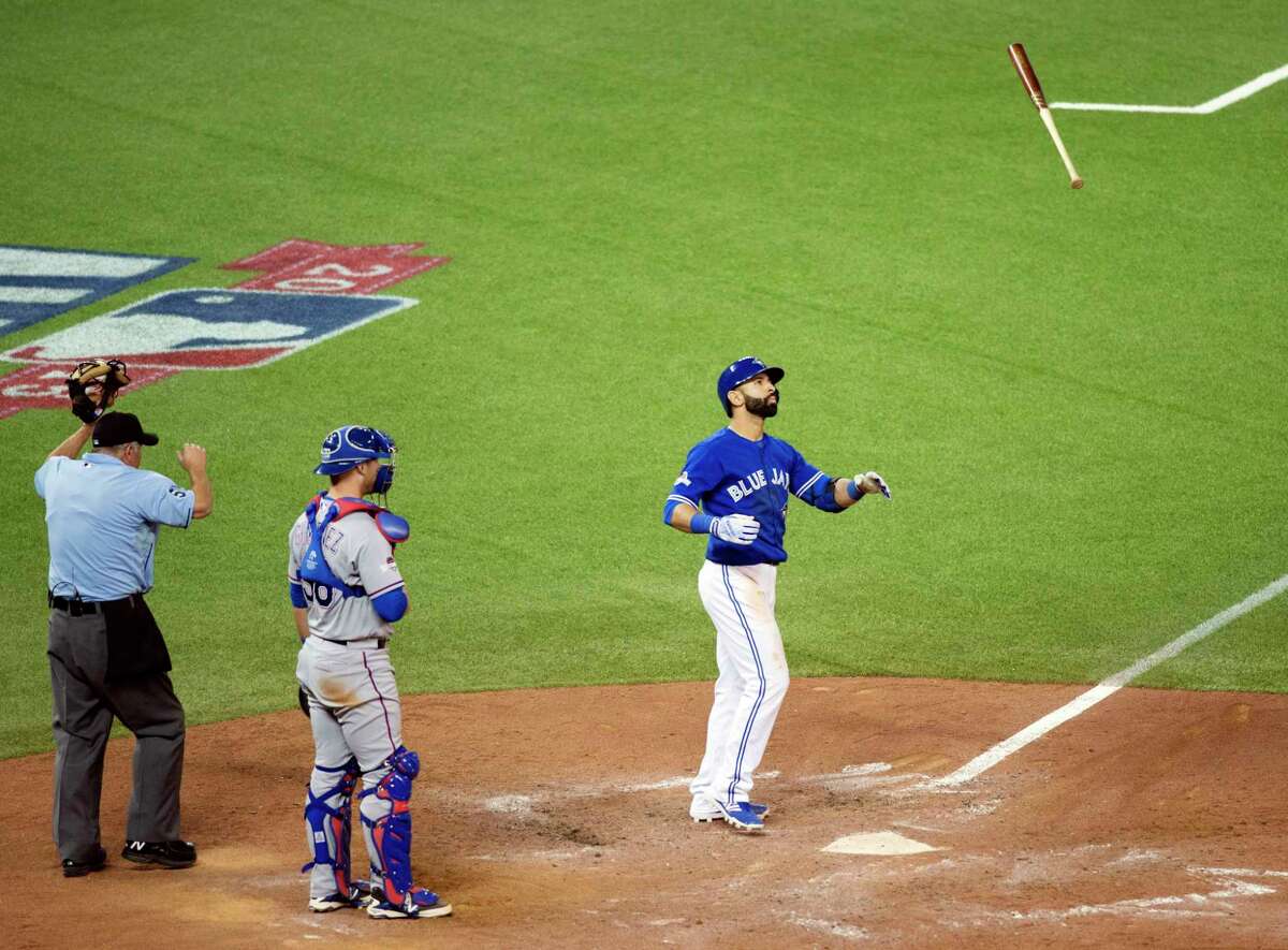 The Blue Jays’ Jose Bautista flips his bat to celebrate his three-run home run during Game 5 of the ALDS against the Texas Rangers in Toronto.