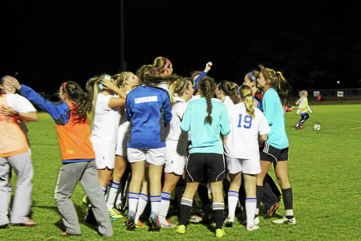 The Lewis Mills girls soccer team celebrates its 2-1 victory over Housatonic Regional on Tuesday night. The win gave the Spartans a share of the Berkshire League title along with the Mountaineers with the teams splitting the season series.