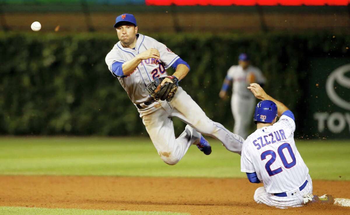 Kris Bryant of the Chicago Cubs throws to first for the final out