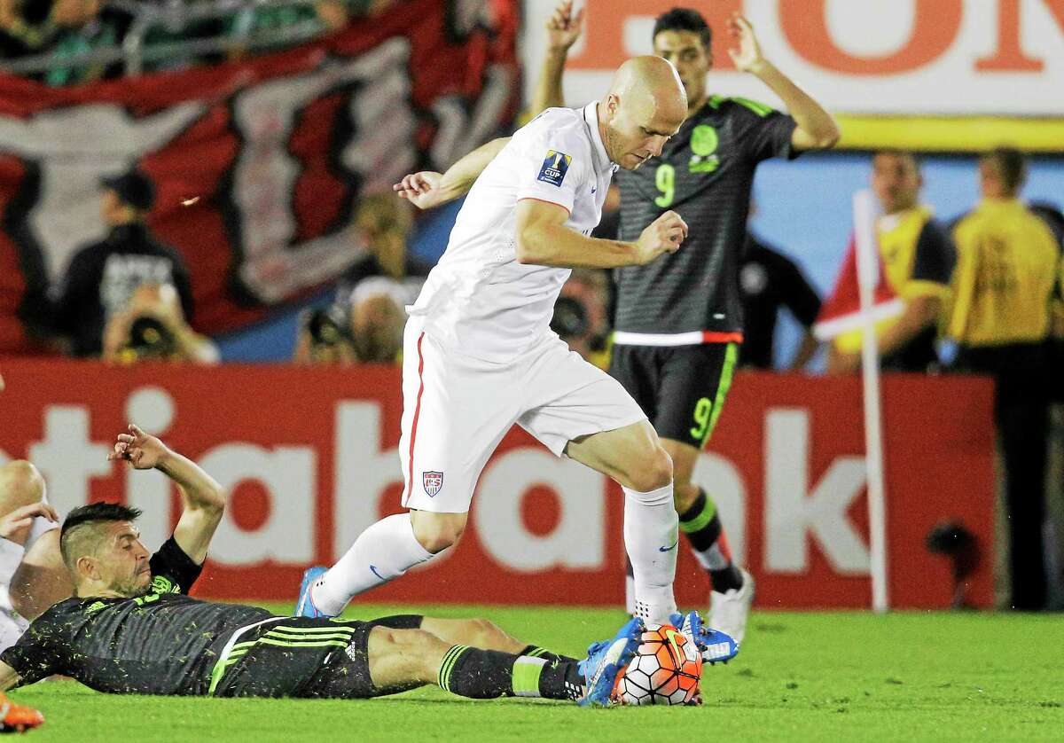 Mexico’s Oribe Peralta, on the ground, attempts to take the ball from the United States’ Michael Bradley during a CONCACAF Cup match in October at the Rose Bowl in Pasadena, Calif.