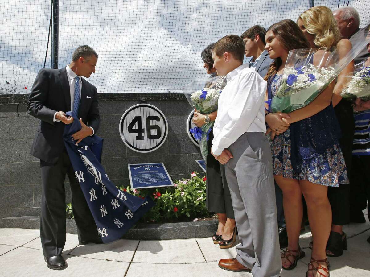 Retired New York Yankees pitcher Andy Pettitte unveils his No. 46 in Yankee Stadium’s Monument Park as his family watches on Sunday.