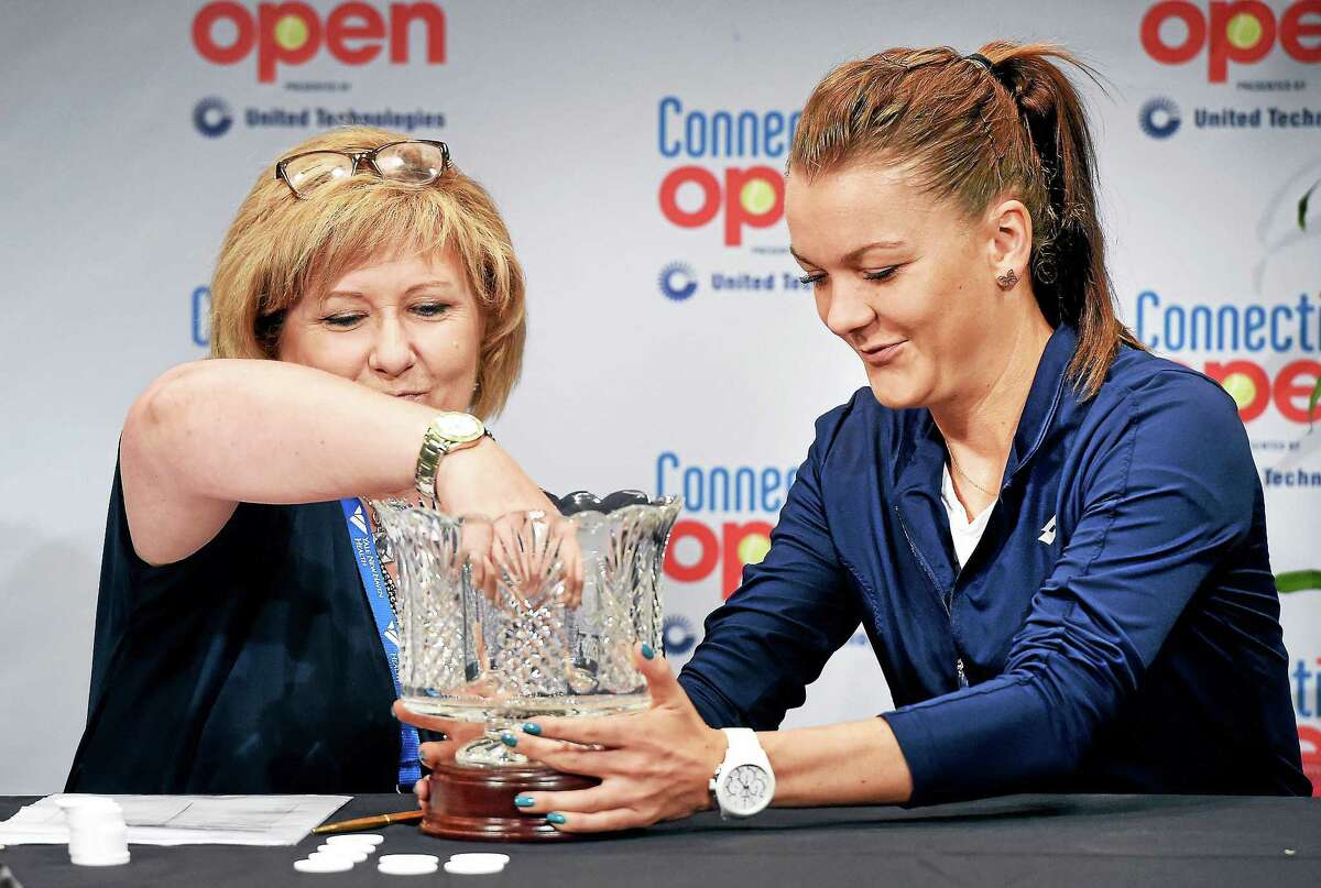 WTA Supervisor Donna Kelso, left, gets assistance with the draw from Agnieszka Radwanska Friday at the Connecticut Open.