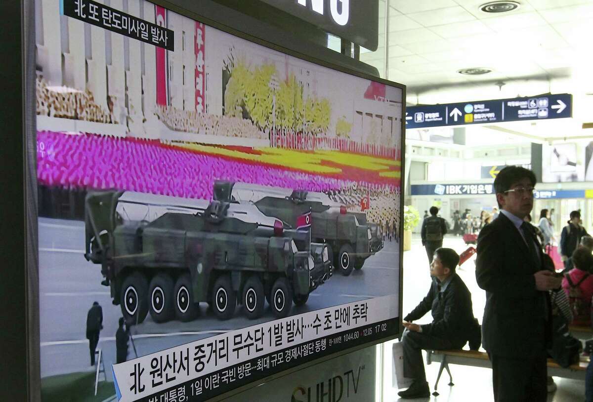 A man walks by a TV news program showing a file footage of North Korean missiles paraded at a military parade in Pyongyang, at Seoul Railway Station in Seoul, South Korea, Thursday, April 28, 2016. A suspected powerful intermediate-range North Korean missile crashed moments after liftoff Thursday, South Korea’s Defense Ministry said, in what would be the second such embarrassing failure in recent weeks. The letters on a screen read: “North Korean launch of a Musudan missile appears to have failed.”