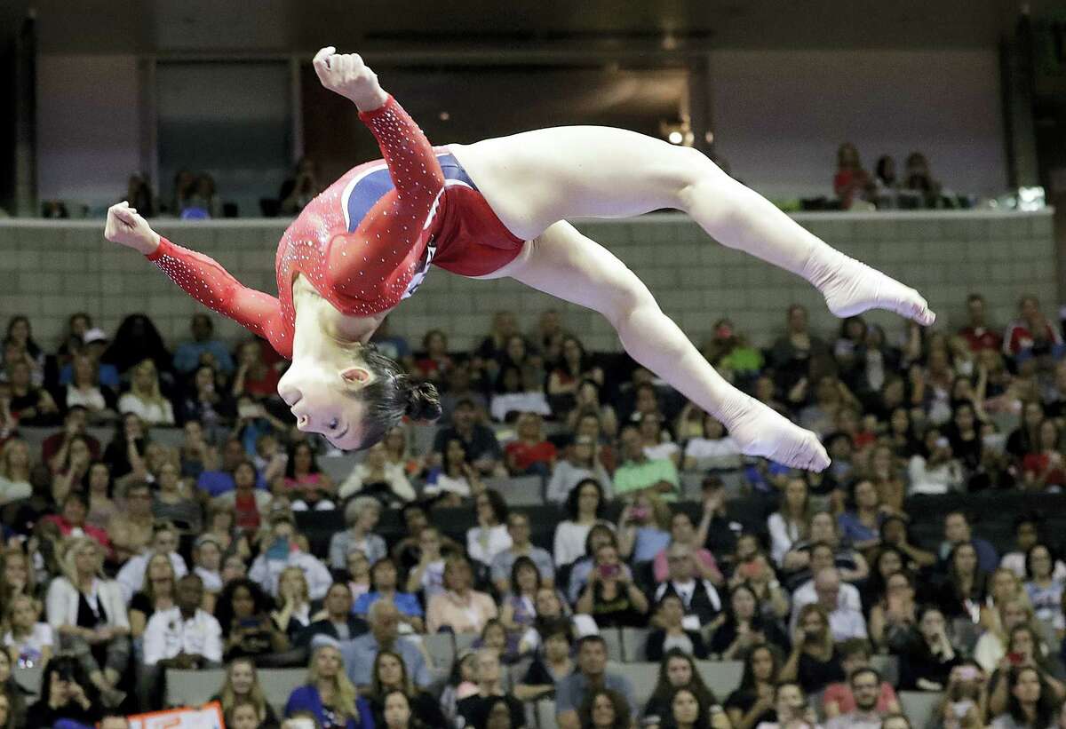 Aly Raisman competes on the balance beam during the women’s U.S. Olympic gymnastics trials.