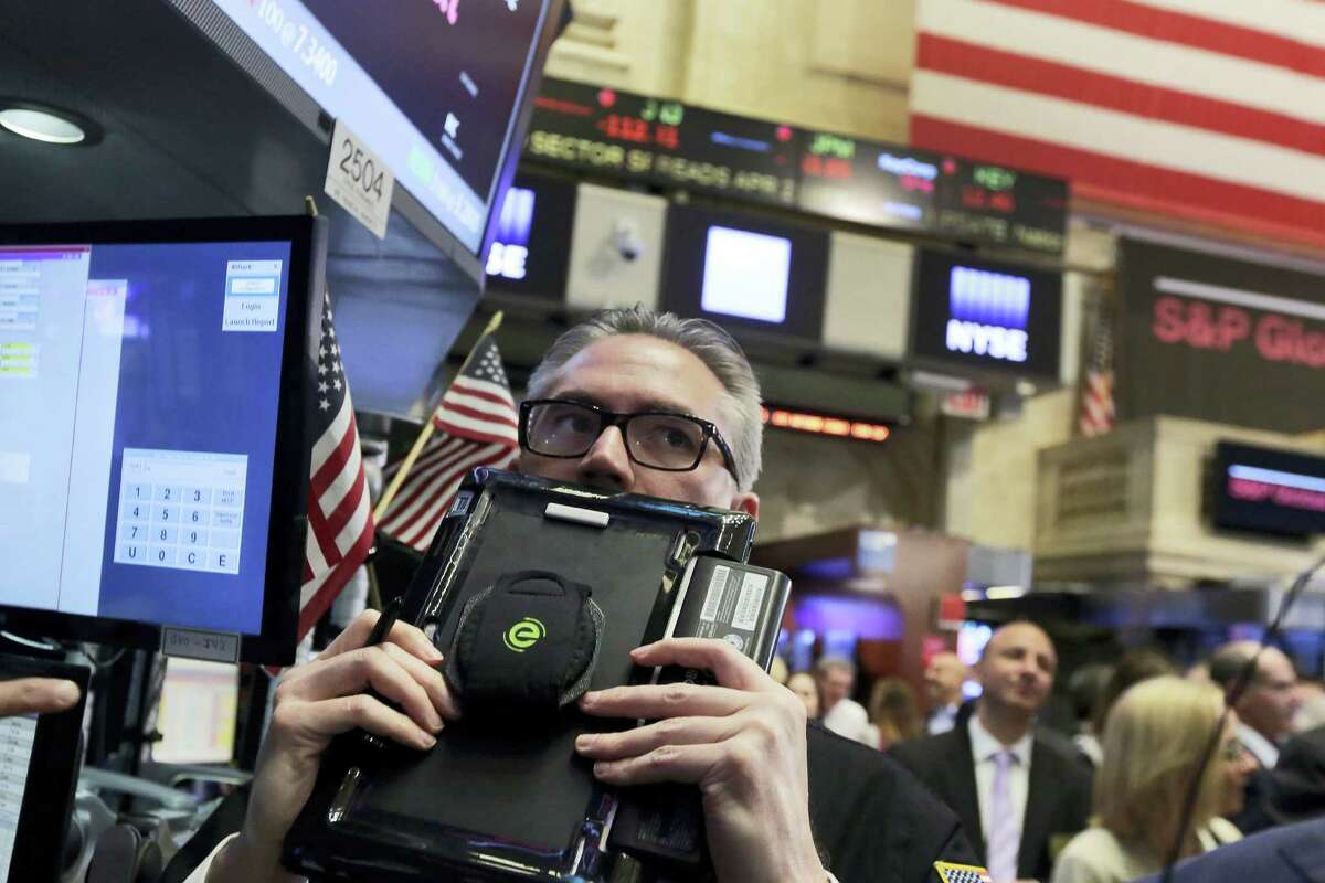 Trader Eric Schumacher works on the floor of the New York Stock Exchange Thursday.