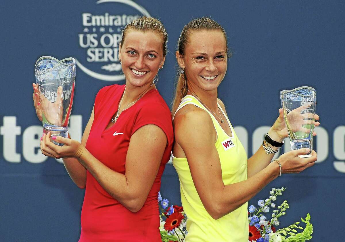 Petra Kvitova, of the Czech Republic, left, and Magdalena Rybarikova, of Slovakia, celebrate after Kvitova's 6-4, 6-2 victory in the final match of the Connecticut Open tennis tournament in New Haven, Conn., on Saturday, Aug. 23, 2014. (AP Photo/Fred Beckham)