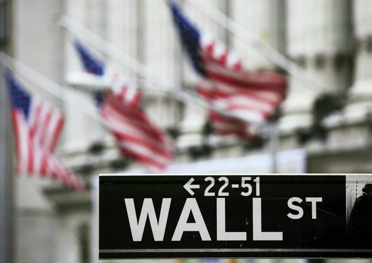 FILE - This April 22, 2010, file photo, shows a Wall Street sign in front of the New York Stock Exchange. Global shares rose Monday, July 11, 2016, after Wall Street rose on a strong U.S. employment report and as investors recovered gradually from post-Brexit jitters.