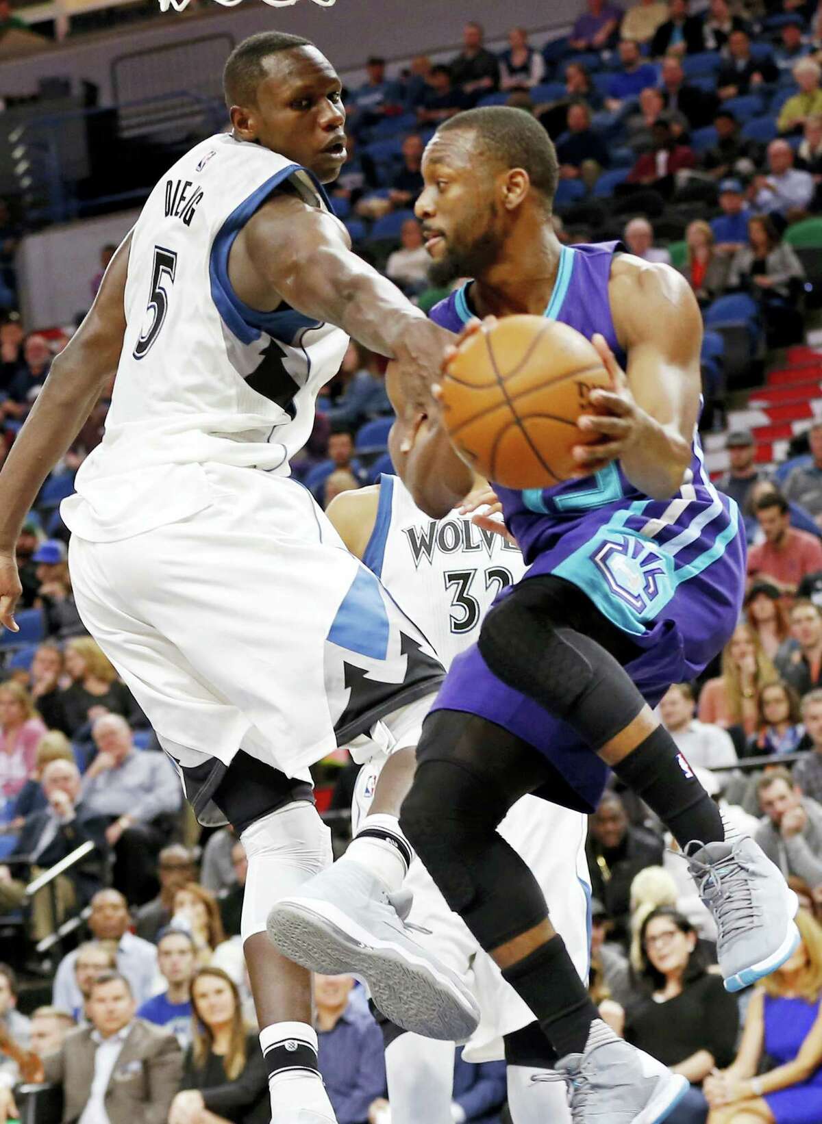 Charlotte Hornets’ Kemba Walker, right, goes airborne around Minnesota Timberwolves’ Gorgui Dieng of Senegal in the second half of an NBA basketball game Tuesday, Nov. 15, 2016 in Minneapolis. The Hornets won 115-108. Walker led the Hornets with 30 points.