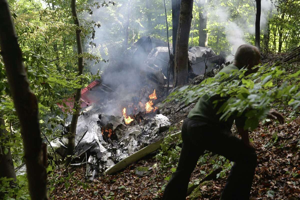 The burning debries of a light aircraft photographed near the village of Cerveny Kamen, Slovakia on Aug. 20, 2015. Two planes carrying dozens of parachutists collided in midair over western Slovakia, killing several people, officials said.